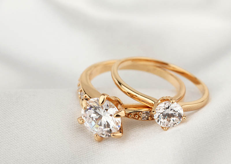 jewelry rings with diamond on white cloth, soft focus Boats docked at a small marina